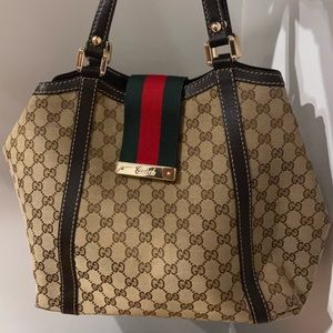 large gucci monogram tote with green and red buckle.